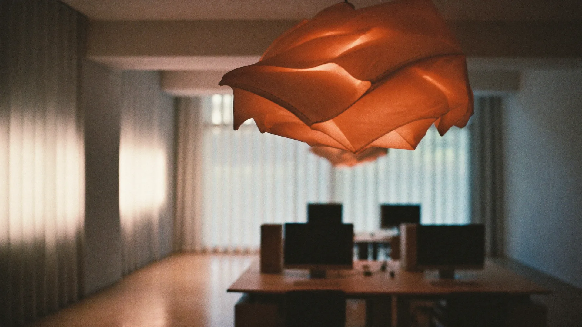 A calm open-plan office with monitors